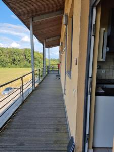 a walkway in a building with a view of a field at l'heure des vacances in Froid-Chapelle