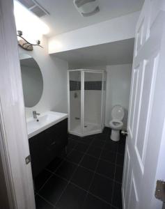 a bathroom with a sink and a toilet at 2 bedroom cozy entire ground floor in Vaughan