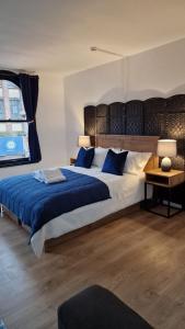 a bedroom with a large bed with blue pillows at Studio Bleu in Birmingham