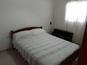 a bedroom with a bed with a striped blanket at Vacaciones Asequible in Necochea