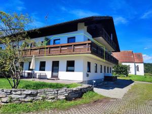 a house with a balcony on top of it at Apartment bei Wasserburg am Inn in Soyen +3 photos