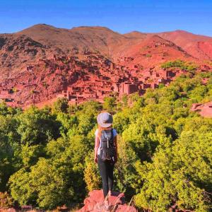 a woman standing on top of a rock overlooking a valley at Dar Megdaz in Megdaz +208 photos