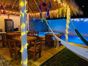 a hammock in a restaurant with a pool at Posada chachalacas in Chachalacas