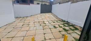 a patio with a white fence and weeds at Casa Paraiso da Montanha in São Thomé das Letras