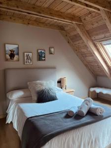 a bedroom with a large bed with two towels on it at Ca de Palomera Vall d’Aran in Les