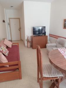 a living room with a table and a couch at depto pleno centro a 3 cuadras del mar in Mar del Plata