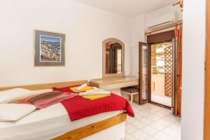 a bedroom with a large bed and a bathroom at Alexander Beach Hotel in Kalamaki Heraklion