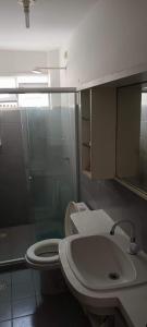 a bathroom with a toilet and a sink at Chalé Barra Sirinhaém in Sirinhaém