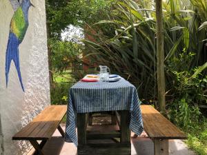 a table with a blue table cloth on it at Colibrí in Barra de Valizas