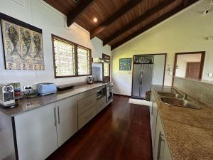 a large kitchen with white cabinets and a sink at Latui Lodge in Savusavu