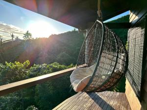 a hammock on a balcony with a view of a mountain at Latui Lodge in Savusavu