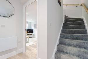 a staircase in a house with white walls at Rock Mill - 2-Bedroom Duplex Apartments in Stoney Middleton