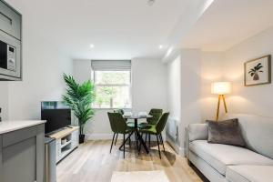 a living room with a couch and a table at Rock Mill - 2-Bedroom Duplex Apartments in Stoney Middleton