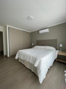 a bedroom with a large white bed in a room at EN EL CENTRO DE LOBOS in Lobos
