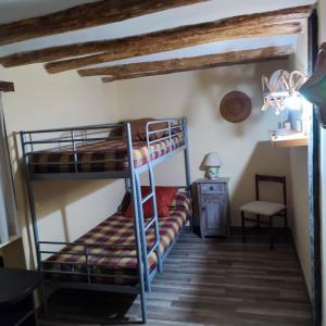 a room with two bunk beds and a desk at Casa Pradillo 