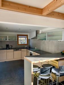 a kitchen with a counter and some chairs in it at Kleines Reihenhaus im Chiemgau in Siegsdorf