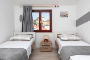 Postel nebo postele na pokoji v ubytování Apartments Janjac