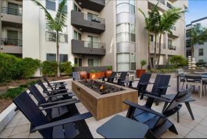 a patio with chairs and a fire pit in front of a building at Gorgeous 2bdr Home in Marina in Los Angeles