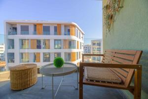 a chair and a table on a balcony at Appartement luxueux et lumineux Maarif Casablanca in Casablanca