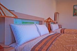Postel nebo postele na pokoji v ubytování Ti Siang B&B