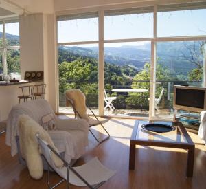 a living room with a view of a mountain at GLMB - Location Mont-Blanc in Saint-Gervais-les-Bains