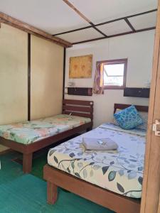 a room with two beds and a window at Genevieve Guest House in Maria