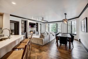 a kitchen and living room with a table and a couch at Elkhorn Lodge in Avon