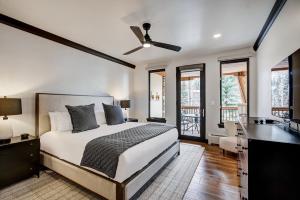 a bedroom with a bed and a ceiling fan at Elkhorn Lodge in Avon