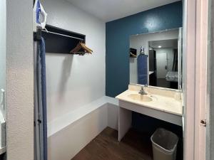 a bathroom with a sink and a mirror at Studio 6 Hemet, CA in Hemet