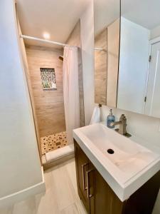 a bathroom with a sink and a shower at Wonder Place Less than 100 feet to the Boardwalk! in Cocoa Beach
