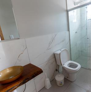 a bathroom with a sink and a toilet at Carolekerry Apartments in São Sebastião