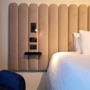 a hotel room with a bed and a wall with at TRIBE Milano Malpensa in Vizzola Ticino