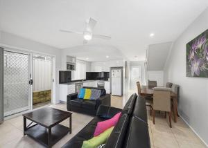 a living room with a couch and a table at Adrift, 5B Scott Street in Crescent Head