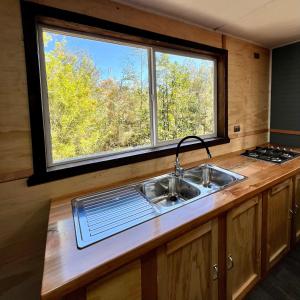 a kitchen with a sink and a window at Parque pomponal in Castro