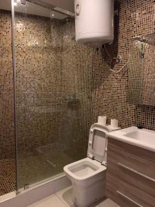 a bathroom with a shower and a toilet and a sink at Villa bella californie in Casablanca