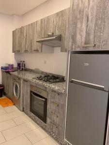 a kitchen with a stainless steel refrigerator and a stove at Villa bella californie in Casablanca