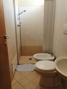 a bathroom with a shower and a toilet and a sink at Case in Residence Torre dell'Orso in Torre dell'Orso