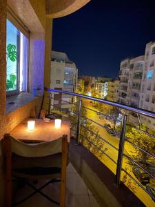 a balcony with a table and a view of a city at chambre privée in Kenitra