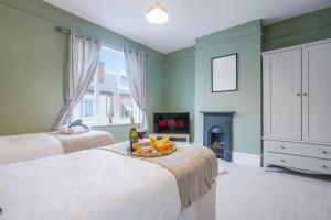 a room with two beds and a fire place at Central House with Parking, Pool Table, Super-Fast Wifi and Smart TV with Virgin Media and Netflix by Yoko Property in Northampton