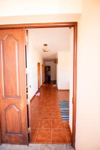 a hallway with a door and a tile floor at Brisas do Atlántico in Santa Maria Madalena