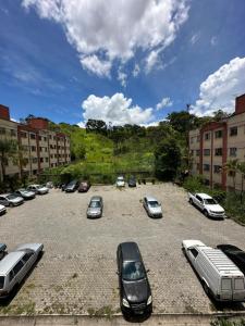 a bunch of cars parked in a parking lot at Apart 3 quartos Fernaodias in Belo Horizonte