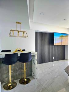 a lobby with two blue chairs and a counter at departamento con vista al mar in Acapulco