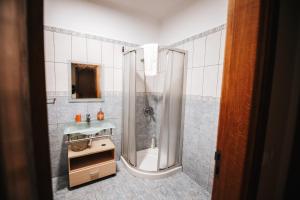 a bathroom with a shower and a sink at Casa da Ribeira in Senhora do Rosário