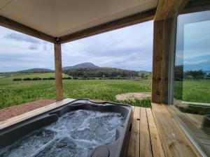 a bath tub on a deck with a view of a field at La Aristobula in Piriápolis