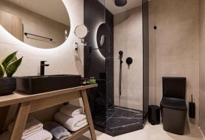 a bathroom with a sink and a shower at Athenarum Portus Life & Style Hotel in Piraeus