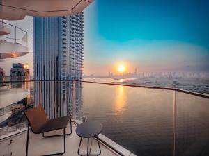 a balcony with a chair and a view of the water at Harbour Point in Dubai