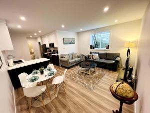 a living room with a couch and a table at Grand Boulevard Basement Suite in North Vancouver
