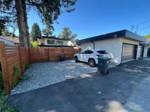 a car parked in a driveway in front of a house at Grand Boulevard Basement Suite in North Vancouver