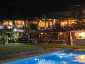 a resort with a swimming pool at night at Casa do Lago in Amarante