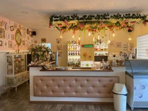 a restaurant with a counter with a bench in a room at Casa do Lago in Amarante